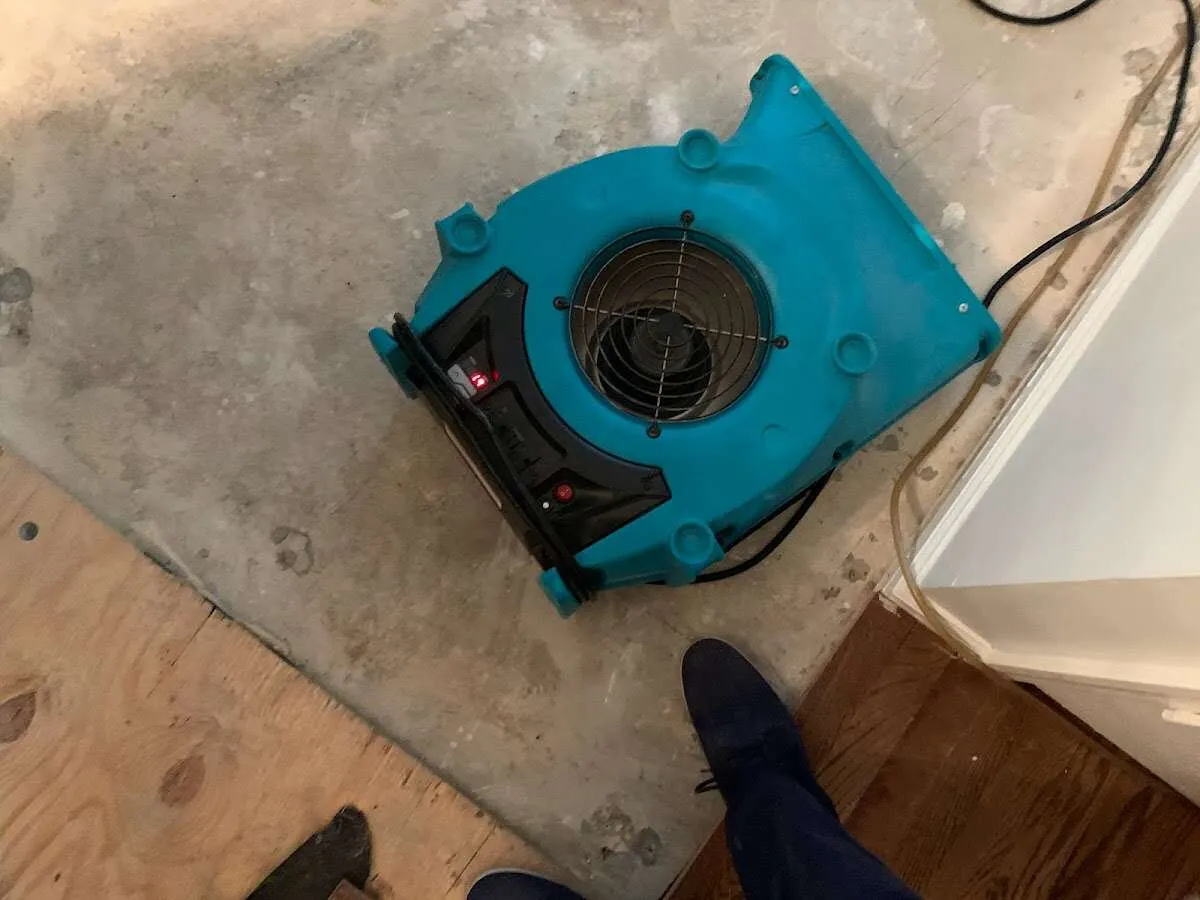 Air mover drying subfloor during Commercial Water Damage Restoration in Barling